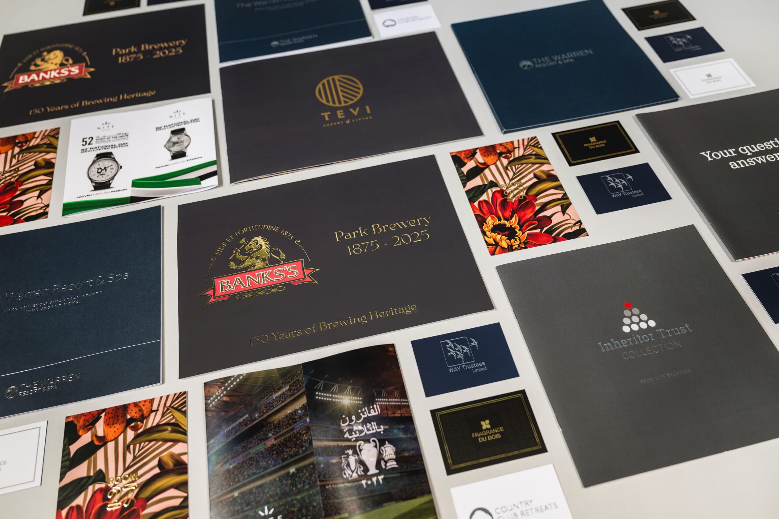 Printed proof sheets and colour bars being checked against print samples in the studio before a production run goes to press