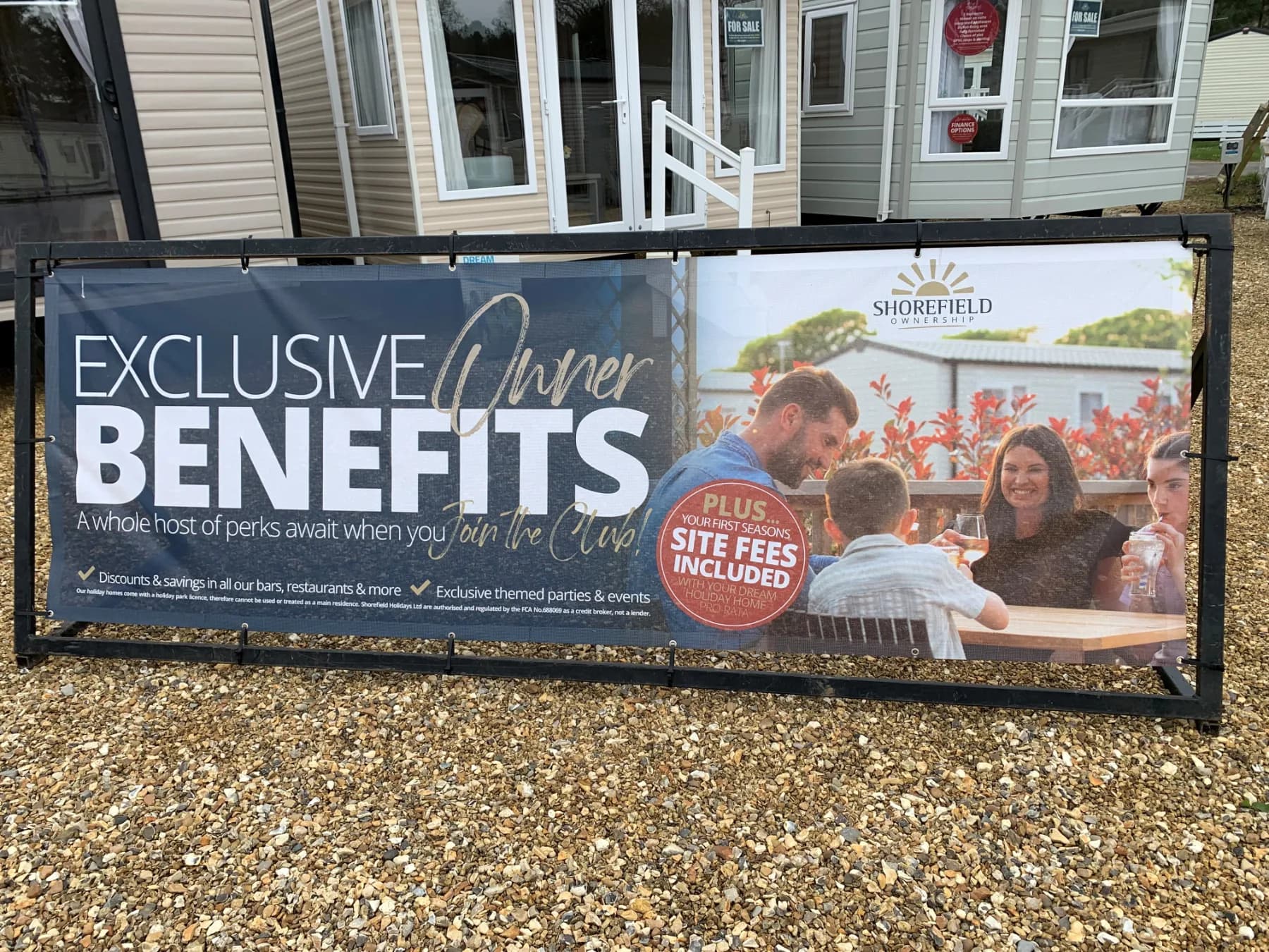 Printed PVC banner fitted to outdoor railings with eyelets and bungee fixings, showing how outdoor print stands up to UK weather