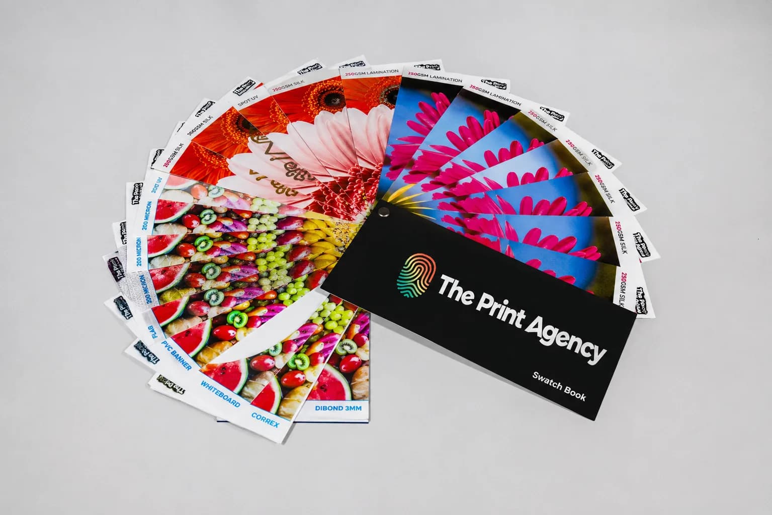 Printed samples on coated and uncoated stock laid out for colour proofing in the studio